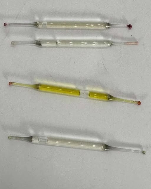What Are These Small Glass Tubes Found Under a Bathroom Cabinet?