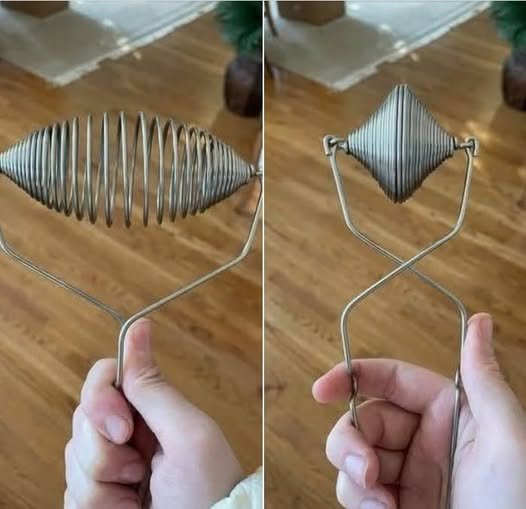 That is a vintage spring wire hot dog / sausage tong (often sold as a “boiling tong” or hot dog retriever).